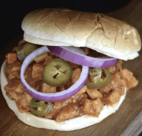 Sloppy joe sandwich with onions and jalapenos.